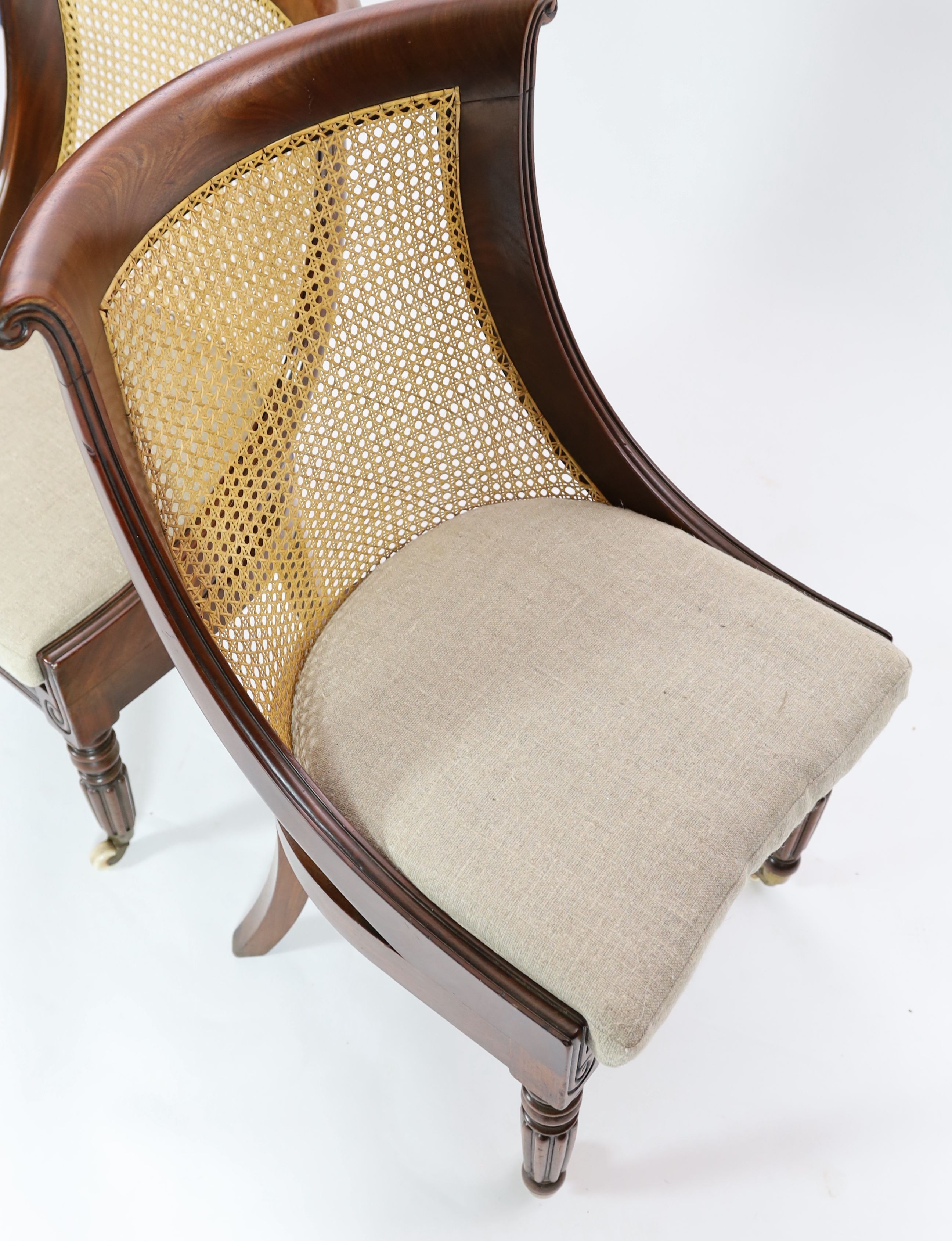 A pair of late Regency mahogany bergere side chairs